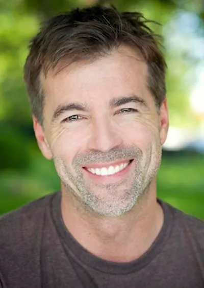 man showing off his restored smile thanks to services from Ankeny Dental Professionals