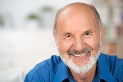 man showing off his restored smile thanks to dental crowns from Ankeny Dental Professionals