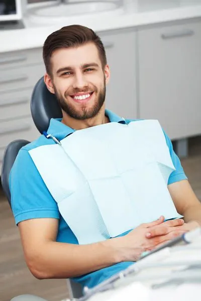 man smiling in the dental chair at Ankeny Dental Professionals in Ankeny, IA