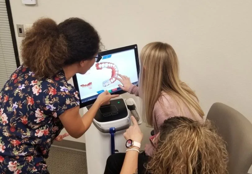 child taking a look at her dental x-rays with the Ankeny Dental Professionals team at their office in Ankeny, IA